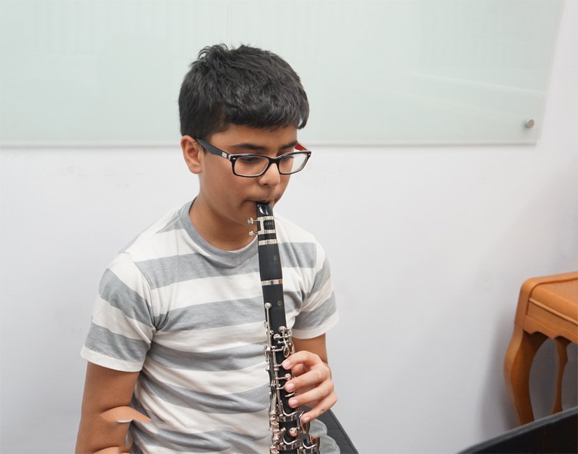 Teenage boy playing at clarinet lesson