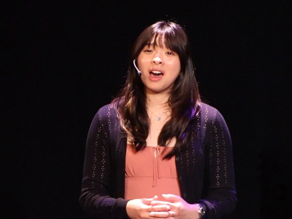 A girl performs on stage with a headset microphone
