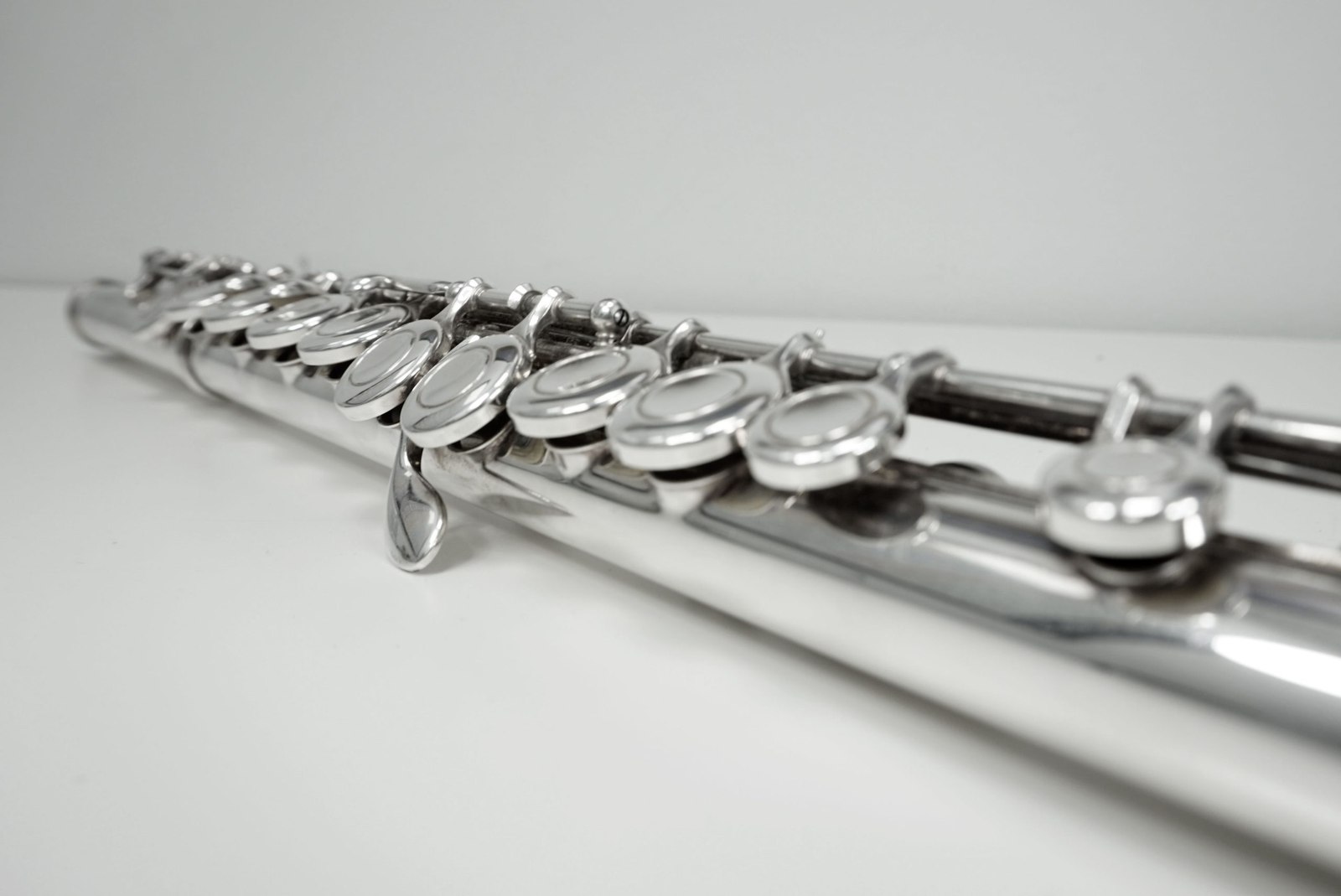 Close-up of a flute's silver keys along its length