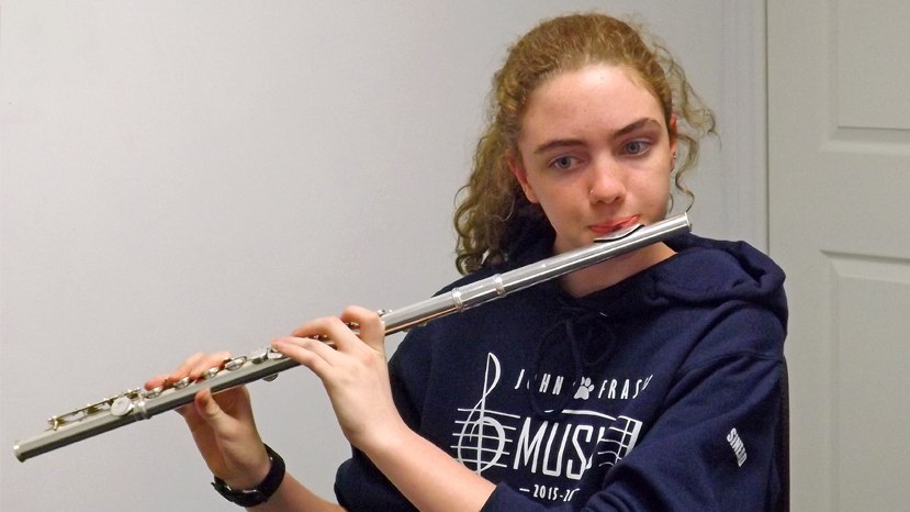 Teenage girl playing the flute