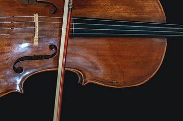 Close-up of a violin body and bow
