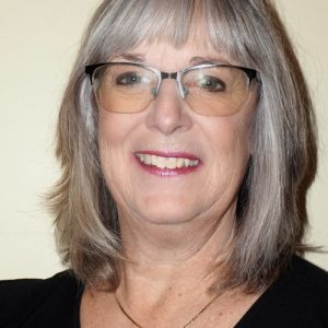 Portrait of a piano teacher in Mississauga, The teacher is smiling.